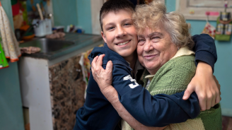 A boy hugging his grandmother